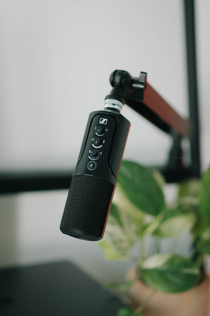 Close-up of a black microphone on a stand, perfect for recording and broadcasting.